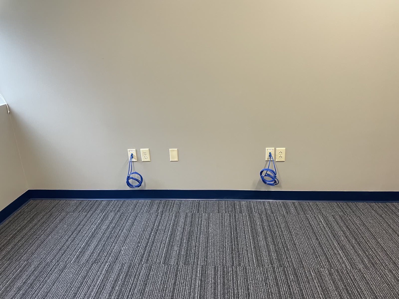 Finished office space with completed network drops and coiled patch cables