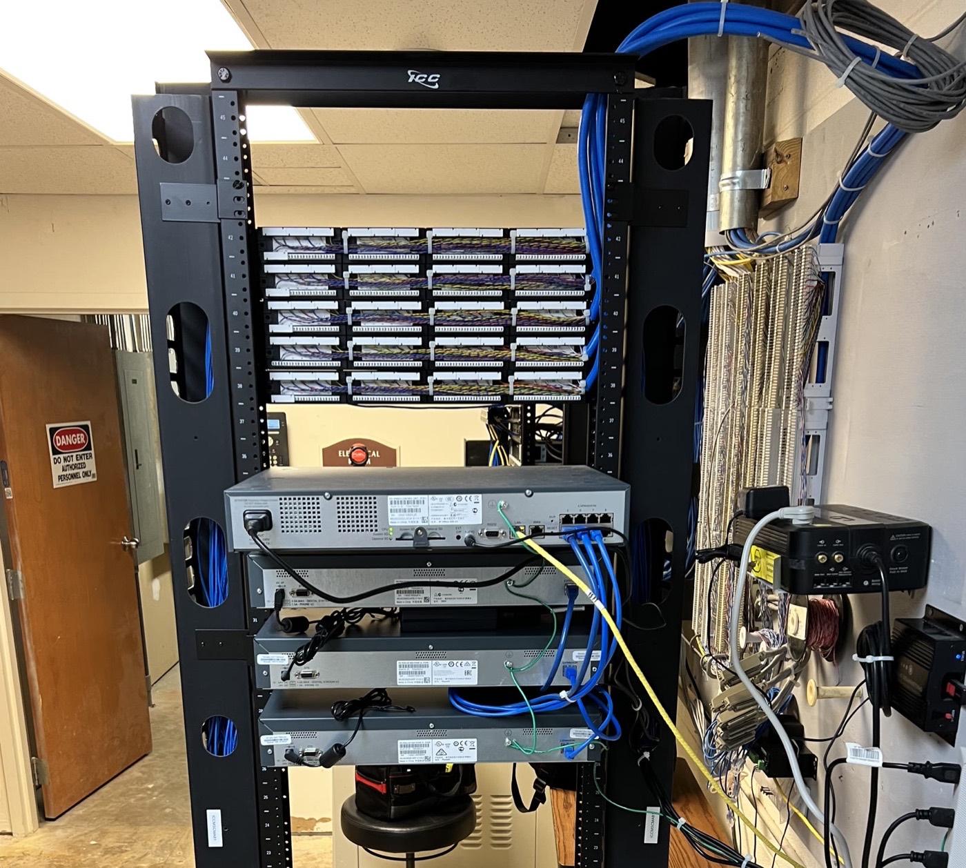 Telecom room build-out with relay rack, riser cable and punch-down field
